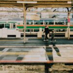 A father and son walk along the platform at a Tokyo train station during the early evening.