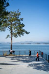 People enjoying a peaceful lakeside view by Qiandao Lake, China.