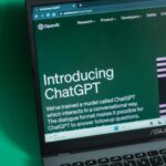 Laptop screen displaying the introductory page of ChatGPT on OpenAI's website.