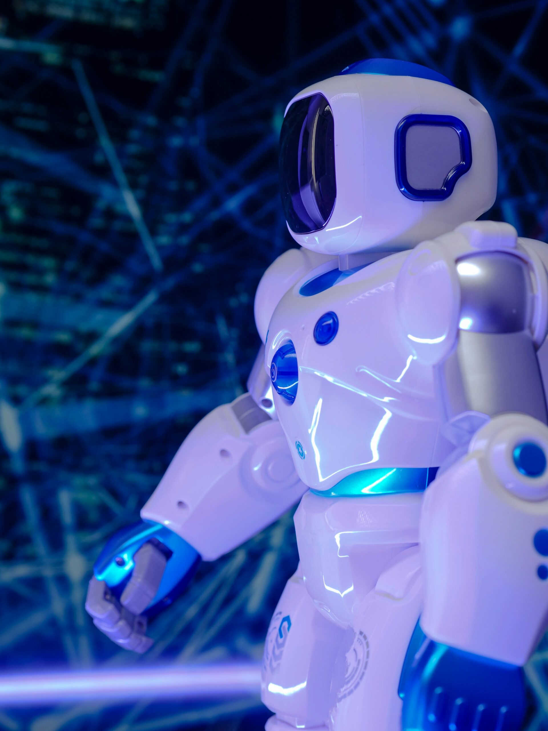 Close-up of a modern humanoid robot with glowing blue lights and futuristic design.