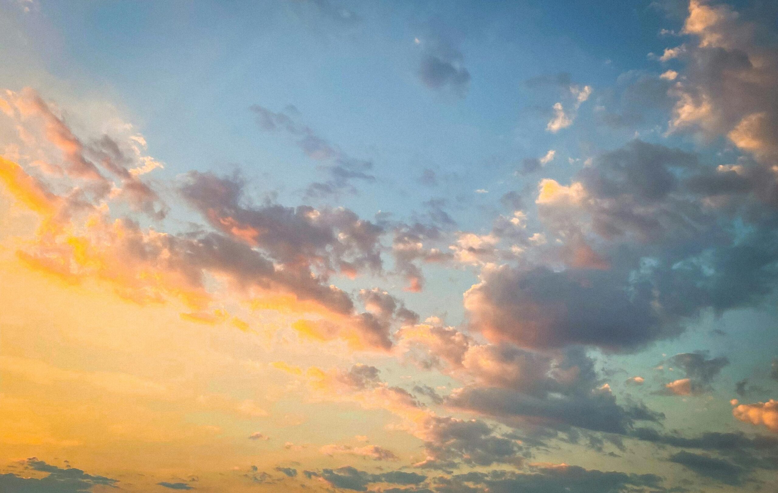 A stunning sunset sky over Kavala, Greece, with vibrant hues and scattered clouds.