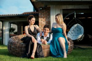 Three adults enjoying a stylish outdoor setting, showcasing fashion and friendship.