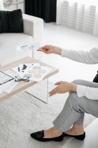 A professional distributes documents during a meeting in a modern office environment.